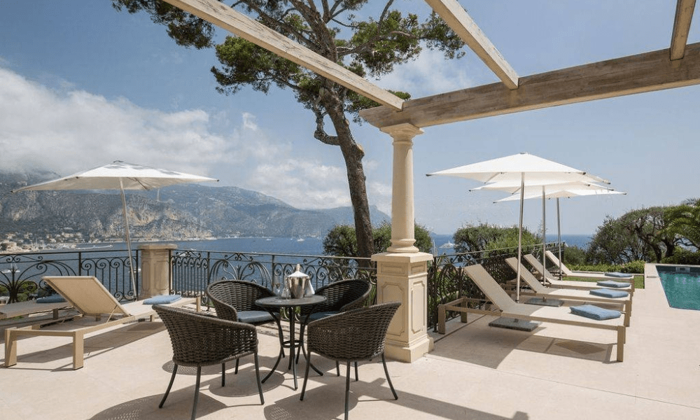 Terrace dining area with ocean panorama and sunset glow